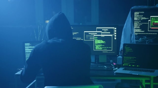 Close-up of computer hacker typing a code to break the server. Failing attempt of cyber crime in the company at night.