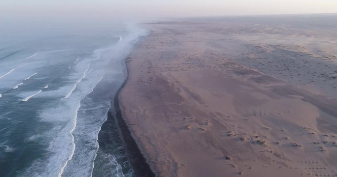 4K aerial zoom in view of the shoreline of the  Atlantic Ocean on the Skeleton Coast,Namibia