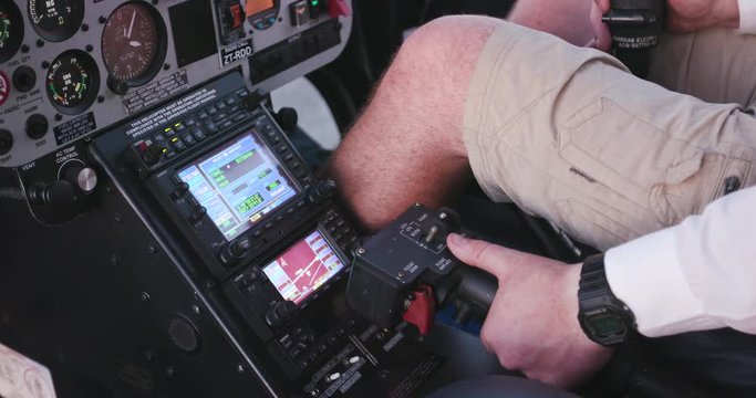 View of instrument panel and helicopter pilot lifting the Collective to take off