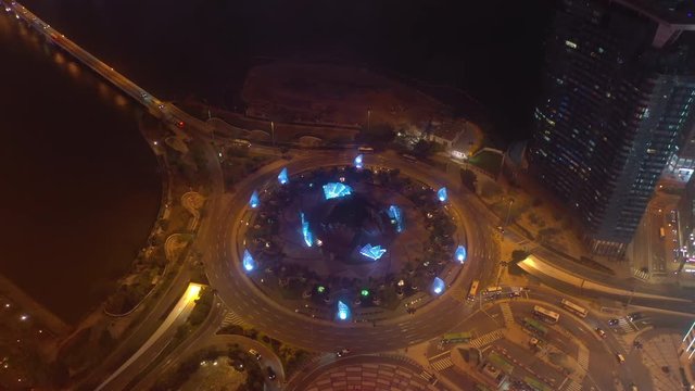 night time illuminated macau city traffic circle bay aerial topdown panorama 4k china