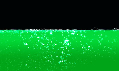 green water with air bubbles water on black background.