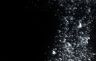 air bubbles water splash on black background.