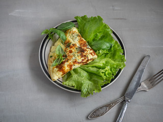 Omelet Breakfast on lettuce leaves on a blue round plate