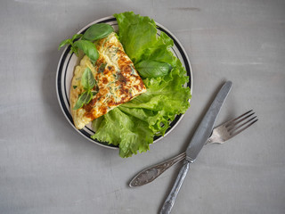 Omelet Breakfast on lettuce leaves on a blue round plate and a dining fork
