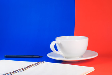 cup of coffee and notebook on table