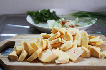 sweet potato cut in little pieces on chop board