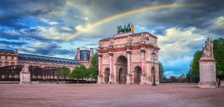 Arc de Triomphe at the Place du Carrousel in Paris, France. Rainbow in the sky.