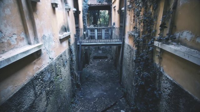 Dark corridor between old abandoned buildings 