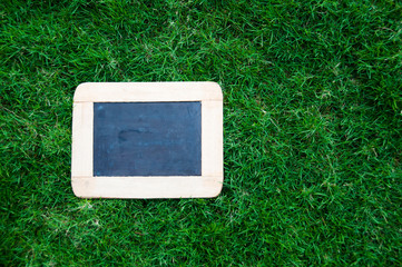 Blackboard with easel and wording menu on green grass background stock photo