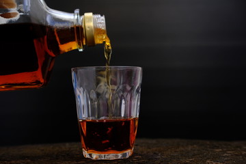Close up whisky on old wood table