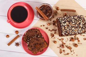 Dark cake with chocolate, cocoa and plum jam, cup of coffee, delicious dessert