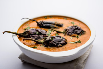 Baingan masala / Eggplant / brinjal curry served in bowl or pan, selective focus