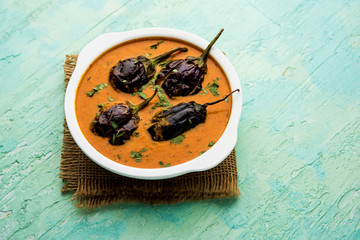 Baingan masala / Eggplant / brinjal curry served in bowl or pan, selective focus
