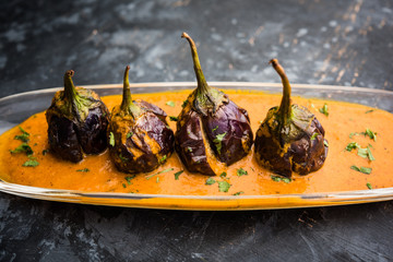 Baingan masala / Eggplant / brinjal curry served in bowl or pan, selective focus