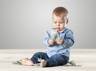 Little child blond girl having fun on a swing