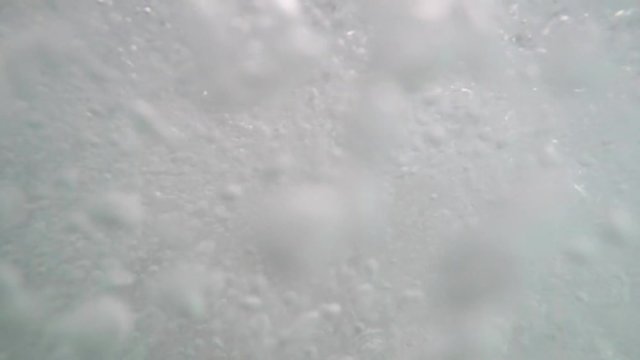 Tide of underwater bubbles in the hydromassage spa pool for health and pleasure. No people in. Underwater view