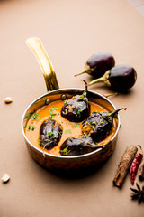 Baingan masala / Eggplant / brinjal curry served in bowl or pan, selective focus