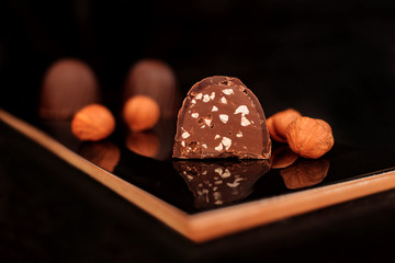 candy cane with hazelnuts on a black background