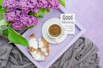 Breakfast. A lilac tray with a cup of coffee and bagels (croissants) and a card for text and an awesome sprig of lilacs.