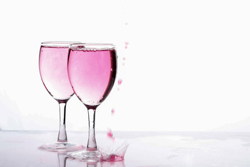 Red food coloring diffuse in water inside wine glass