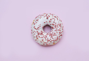 Delicious donut on light pastel color background. National Donut Day concept.