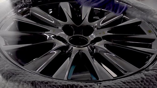 Automobile disc restoring. Painter painting light alloy wheel with spray ,Professional coating of ceramic wheels
