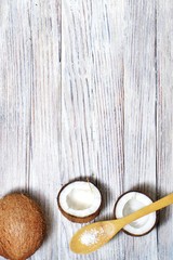 Coconut oil and flakes, tropical leaves and fresh coconuts