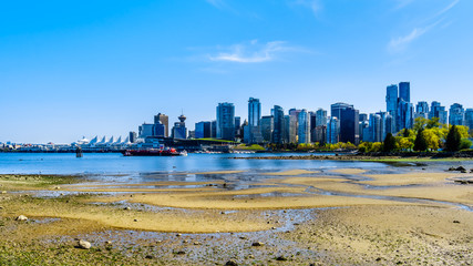 View of the Vancouver Skyline and Harbor. Viewed from the Stanley Park Seawall pathway in beautiful British Columbia, Canada