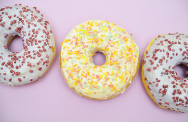 Tasty donuts on pink background. National donuts day.