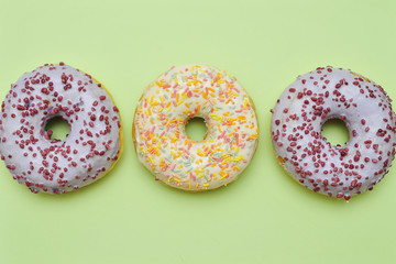 Tasty donuts on pink background. National donuts day.