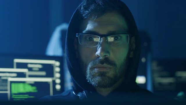 Portrait of hardworking pensive programmer working on data code in a software developing company office.