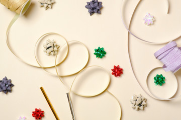 Creative layout with festive accessories over beige background. Concept of celebrating womens bachelorette party, baby shower, wedding anniversary. Flat lay minimalist style composition, top view.