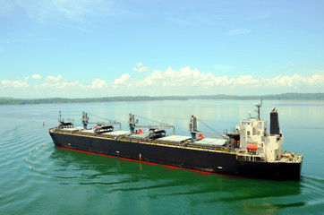 Fototapeta premium Cargo ship transiting through Panama Canal. 