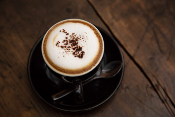 Cup of coffee on wooden table