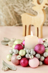 Fototapeta na wymiar Candle holder made of glass balls and silver gift. Beautiful table decoration