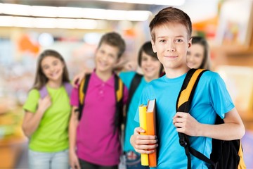 School boy with books and backpack