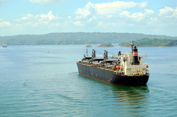 Fototapeta premium Cargo ship transiting through Panama Canal. 