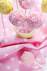 Pink and yellow cake pops.