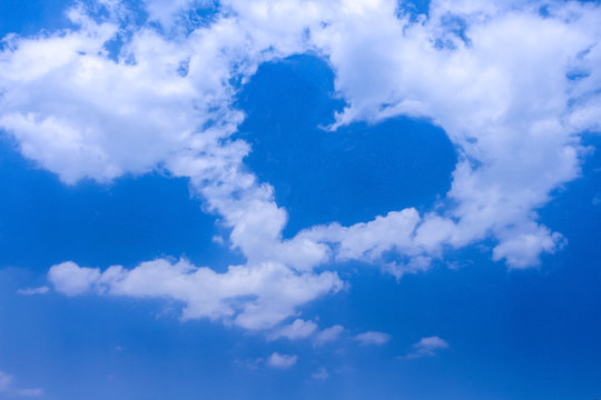 White cloud group patterns with  heart shaped on bright blue sky