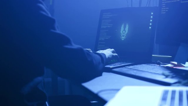Close-up of computer hacker failing to hack security system on laptop. Anonymous man trying to steal data information from the office. Cyber crime concept.