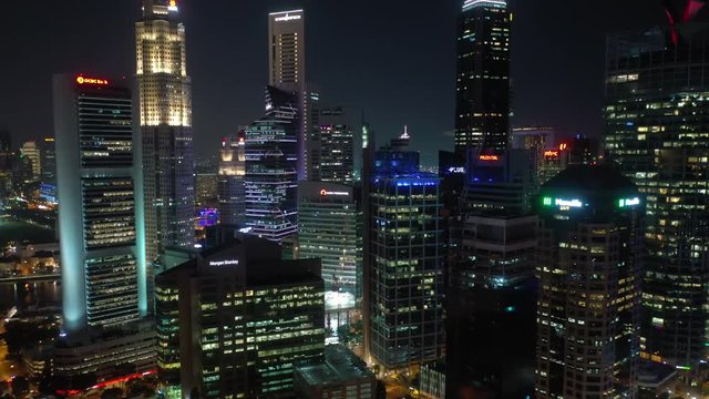 night time illumination singapore downtown rooftops aerial panorama 4k 