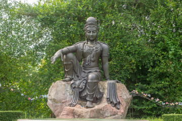 Fototapeta na wymiar The Avalokitesvara Bodhisattva Buddha statue is in garden that is a graceful and respectable