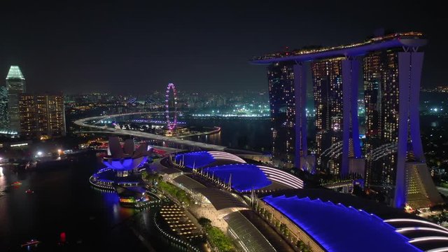 singapore city night time illumination marina bay laser show hotel aerial panorama 4k 