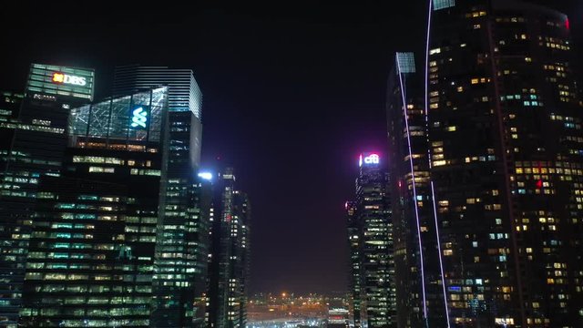 night time illumination singapore downtown buildings front aerial panorama 4k 