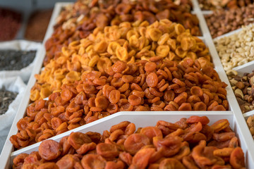 dried fruits and nuts. organic dried dried apricots of different varieties on the shelf of a food store.