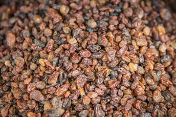 dried fruits. lots of organic raisins in the background. dried raisins background