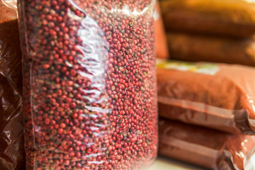 pink pepper seeds in a package on the store shelf