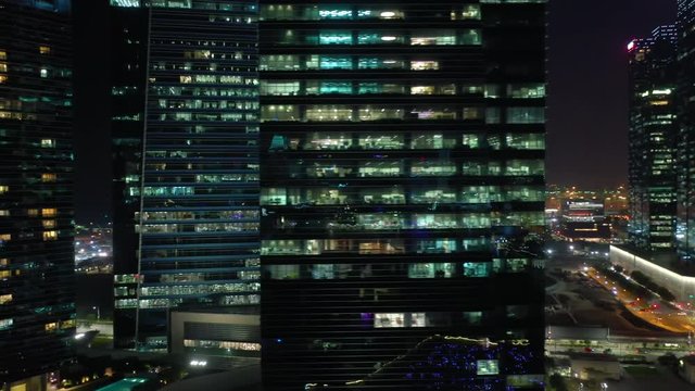 night time illumination singapore downtown buildings front aerial panorama 4k 
