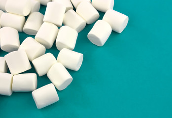 Mini  marshmallows on a blue background. geometric pattern of white marshmallows.