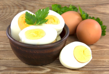 Sliced boiled eggs, with parsley leaves. Cooking a salad with boiled eggs.